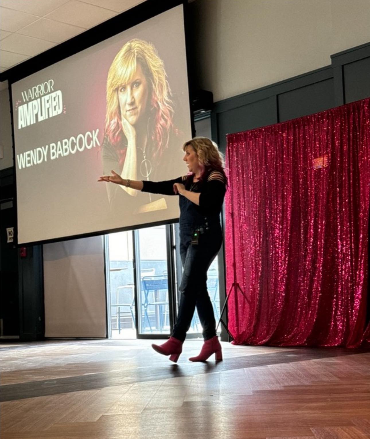 Photo of Wendy speaking live at Warrior Amplified April 2025